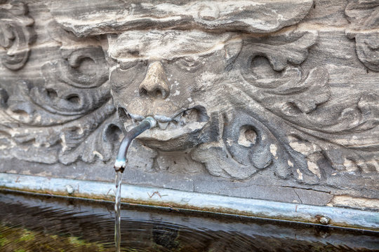 spring fountain water with carved scary face 