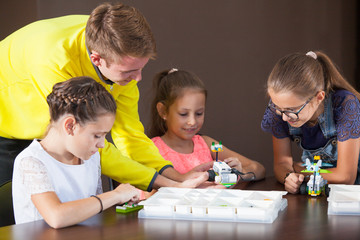 Cheerful smiling children are building a constructor.