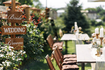 Outdoor wedding ceremony. index sign bride and groom