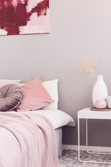 Copy space on beige wall of trendy bedroom interior