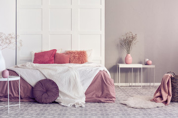 Fashionable pink, white and beige scandinavian bedroom interior