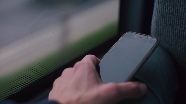 Close-up of a dead smartphone in the hands of a man.