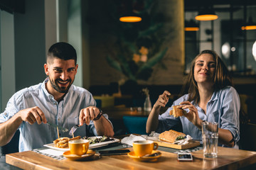 happy couple eating in fancy restaurant