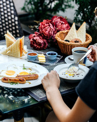a person eating a breakfast at the table