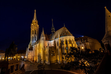 Fototapeta na wymiar Newly renovated Mathias Church in Budapest is a big attraction for tourists all over the world. Budapest's beauty shown at night through many centuries of architecture, Hungary.