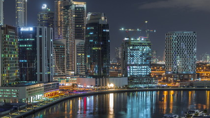 Fototapeta na wymiar Night city Dubai near canal aerial timelapse
