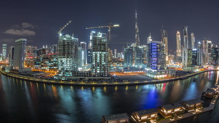 Fototapeta na wymiar Night city Dubai near canal aerial timelapse