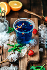 blue beverage with sliced strawberry