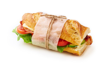 Fresh big baguette sandwich with bacon, chedder cheese, mustard, lettuce and vegetables isolated on white background