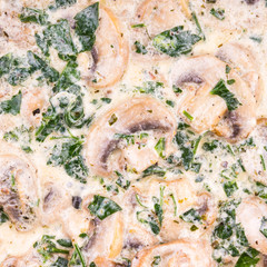 Tasty cream sauce of mushrooms champignon and parsley, close-up, culinary background