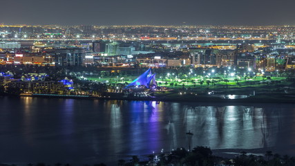 The rhythm of the city with lights from buildings and illuminated roads aerial timelapse