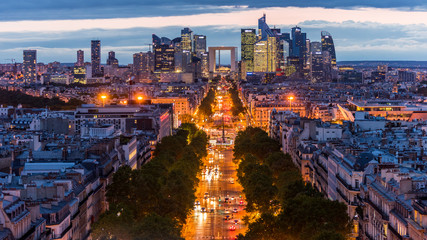  Night view of downtown of Paris with La Grande Arche de la Defense, view from the Arc de Triomphe at the Champs-Elysees Avenue in Paris, France