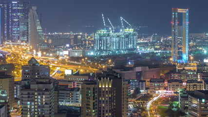 Fototapeta na wymiar View of the rhythm illuminated city with skyscrapers in Dubai aerial timelapse