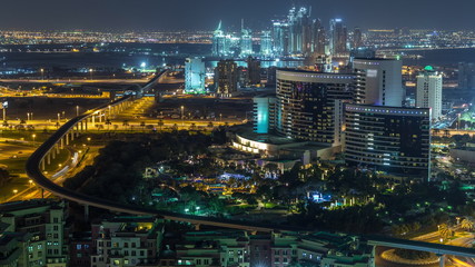 Fototapeta na wymiar Night view of new modern buildings and lights in luxury Dubai city, United Arab Emirates Timelapse Aerial