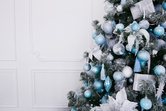 Blue and white Christmas decorations on the New Year tree in the home interior