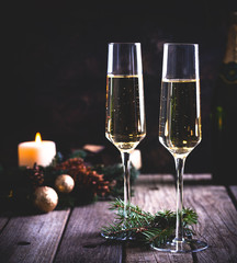 Two Glasses of Champagne With Holiday Decorations in Background