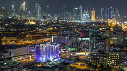 Fototapeta na wymiar Modern view of illuminated buildings appartments and skyscrapers in Dubai Timelapse Aerial