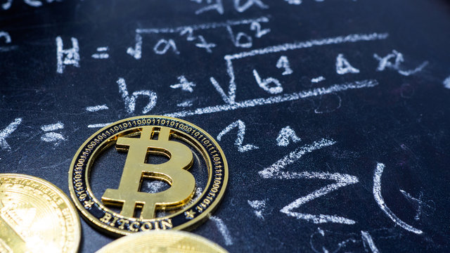 On the blackboard Full of mathematical calculations and bitcoin coin put on it. Concept There is no fixed formula for the price and value of digital currency.