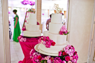 Beautiful wedding set decoration in the restaurant. Chic wedding cake.