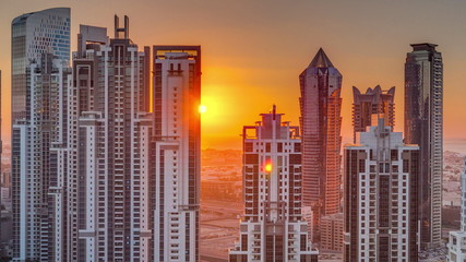 Fototapeta na wymiar Modern residential and office complex with many towers aerial timelapse at sunset in Business Bay, Dubai, UAE.
