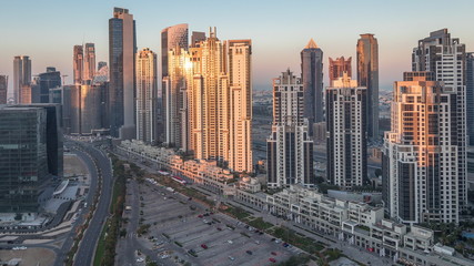 Naklejka na ściany i meble Panorama of Business bay Dubai night to day aerial timelapse.