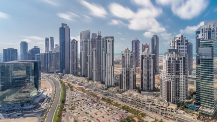 Naklejka na ściany i meble Modern residential and office complex with many towers aerial timelapse at Business Bay, Dubai, UAE.