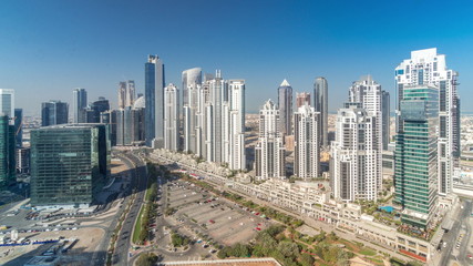 Modern residential and office complex with many towers aerial timelapse at Business Bay, Dubai, UAE.