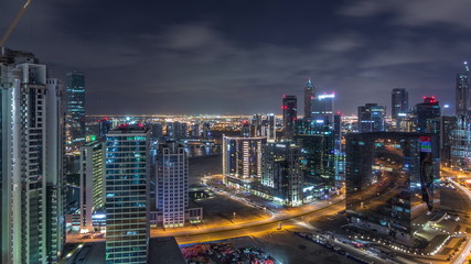 Obraz na płótnie Canvas Aerial view of illuminated buildings and high traffic in modern Dubai city, United Arab Emirates Timelapse Aerial
