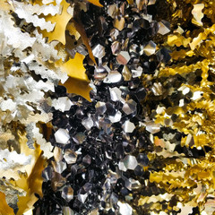 Bright christmas background from colored tinsel. Colored metal foil. Close-up.