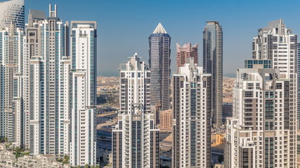 Obraz na płótnie Canvas Modern residential and office complex with many towers aerial timelapse at Business Bay, Dubai, UAE.