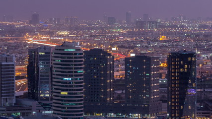 Dubai's business bay towers at evening aerial day to night timelapse.