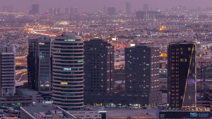 Fototapeta na wymiar Dubai's business bay towers at evening aerial day to night timelapse.