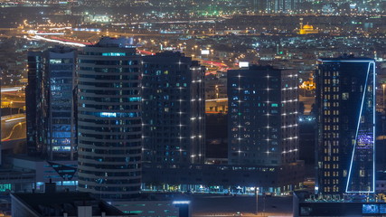 View of bright lights on tall skyscrapers near highways in Dubai city, United Arab Emirates Timelapse Aerial
