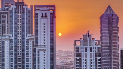Sunset behind modern residential and office complex aerial timelapse at Business Bay, Dubai