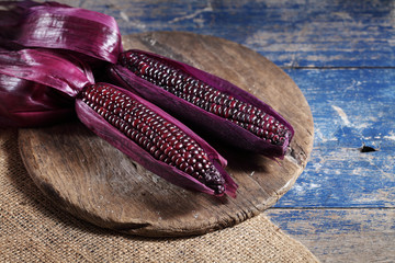 Boiled purple corn on wooden tray in rustic kitchen, Organic sweet purple corn