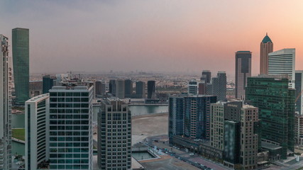 Dubai's business bay towers at evening aerial timelapse.