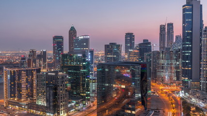 Fototapeta na wymiar Dubai's business bay towers at evening aerial day to night timelapse.