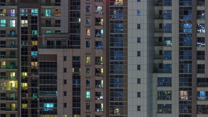 Fototapeta na wymiar Lights from windows of offices in Dubai Aerial Timelapse