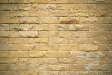 Texture of golden sandstone bricks