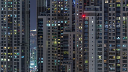 Fototapeta na wymiar Lights from windows of offices in Dubai Aerial Timelapse