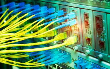 Fiber Optic cables connected to an optic ports and Network cables connected to ethernet ports