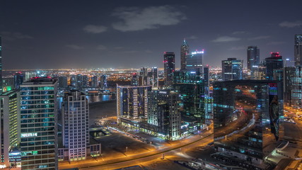 Fototapeta na wymiar Dubai's business bay towers aerial night timelapse.