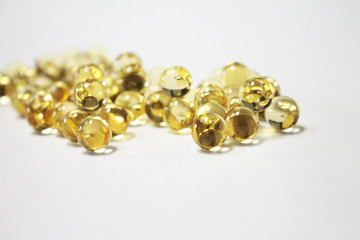  Transparent capsules of yellow color on a white background.