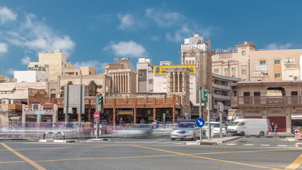 Traffic on intersection near entrance to the Gold Souk timelapse in Deira in Dubai