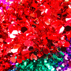 Bright christmas background from colored tinsel. Colored metal foil. Close-up.