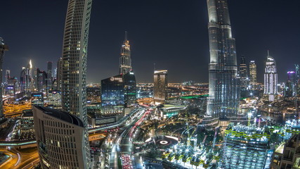 Panoramic skyline view of Dubai downtown with mall, fountains and skyscrapers aerial night timelapse
