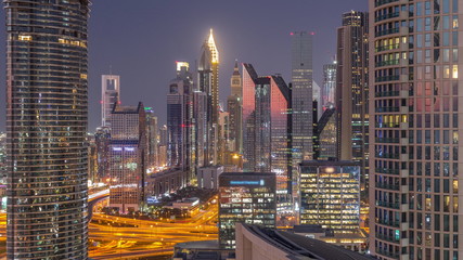 Fototapeta na wymiar Dubai International Financial Centre district with modern skyscrapers day to night timelapse
