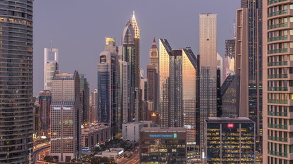 Fototapeta premium Dubai International Financial Centre district with modern skyscrapers day to night timelapse