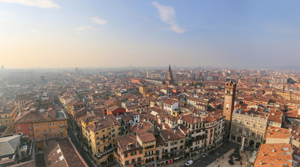 Fototapeta na wymiar Roofs of houses and towers of the Italian old city from the observation deck. Verona, Italy