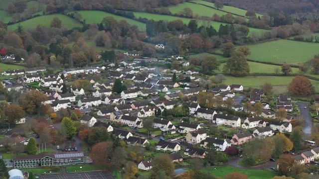 Aerial view smoke coming from a chimney and housing in the market town of Dulverton, located on the River Barle on the edge of Exmoor, UK.